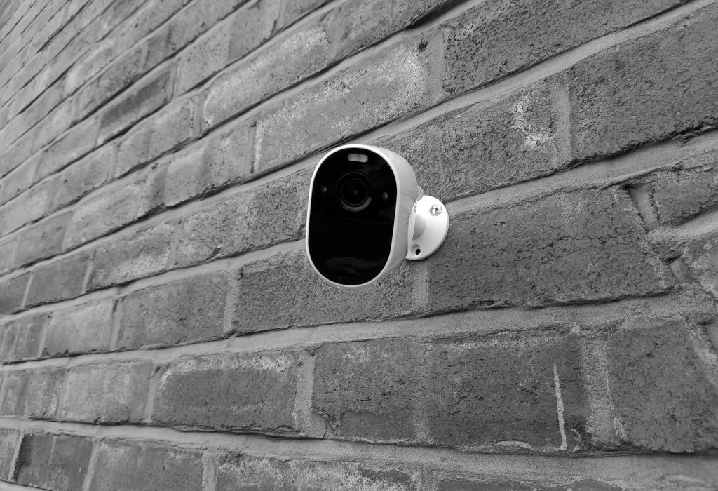 CCTV camera on brick wall for home security.